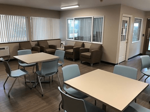 a dining room with tables and chairs and a seating area