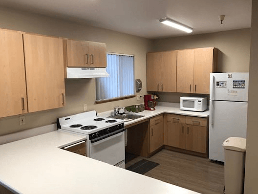 a kitchen with white appliances and wooden cabinets