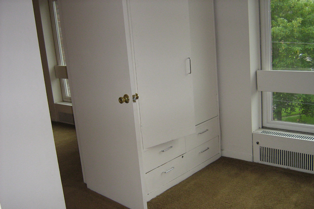 the door to the bedroom is open to the living room