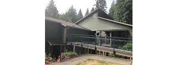 a house with a balcony and a fence