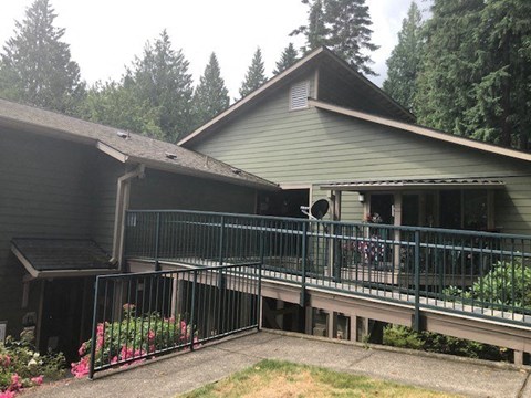 a house with a balcony and a fence