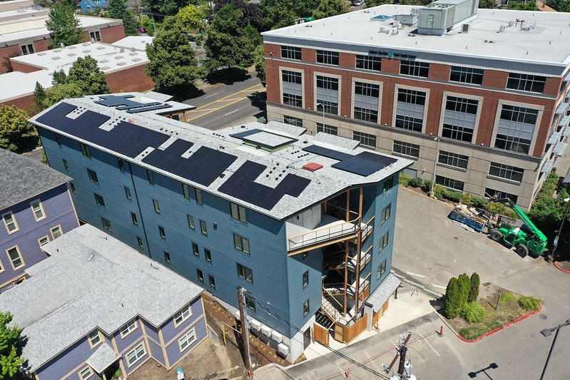 an aerial view of a building with a blue roof