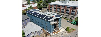an aerial view of a building with a blue roof
