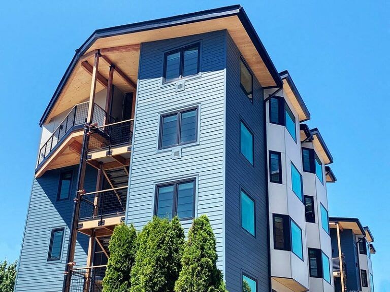 a tall apartment building with scaffolding on top of it