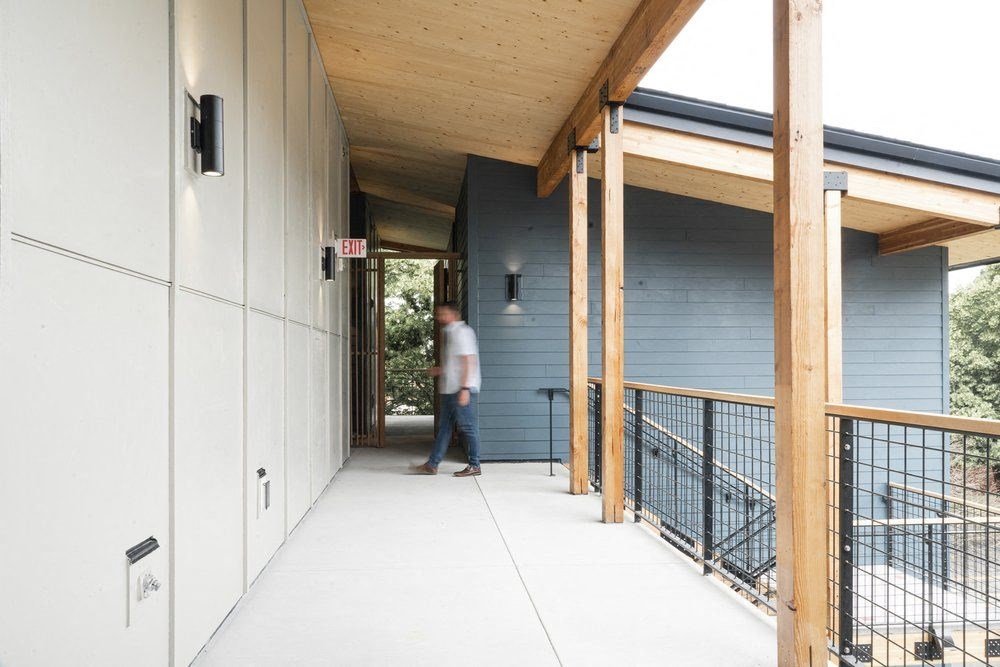 a covered walkway leading to the front door of a house