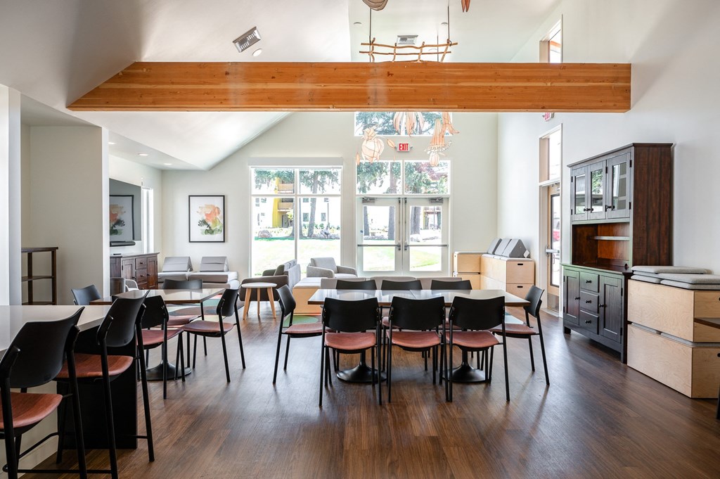 a dining room with tables and chairs and a large window