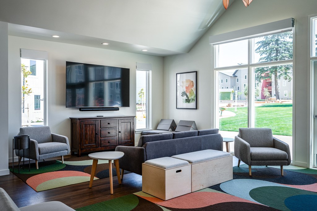 a living room with couches and chairs and a television