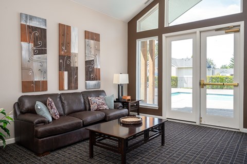 A living room with a brown couch and a coffee table.