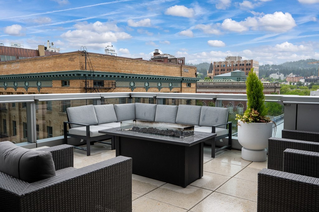a terrace with couches and a table on a balcony