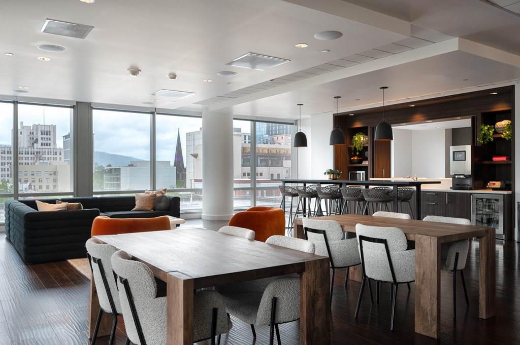 a dining room with a table and chairs and a kitchen with a large window