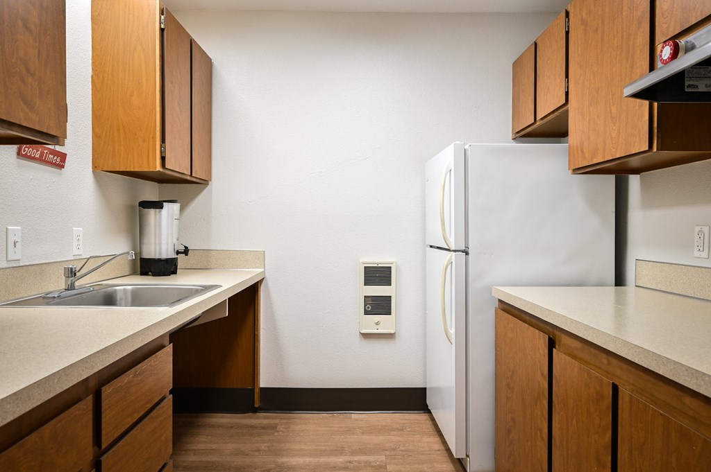 a kitchen with a sink and a refrigerator