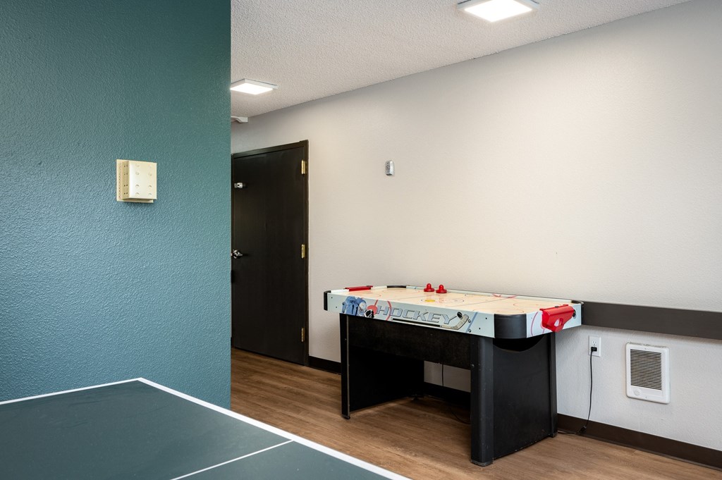 a room with a pool table and a tennis court