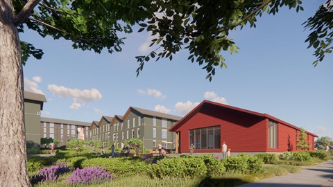 A red building with a green lawn in front of it.