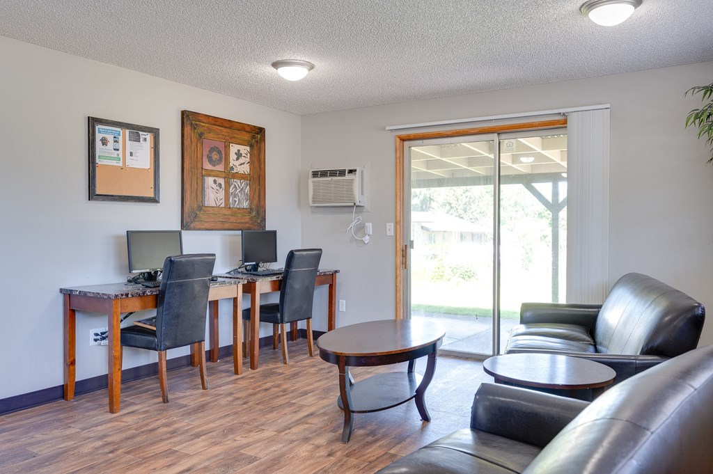 A living room with a couch, chairs, and a coffee table.