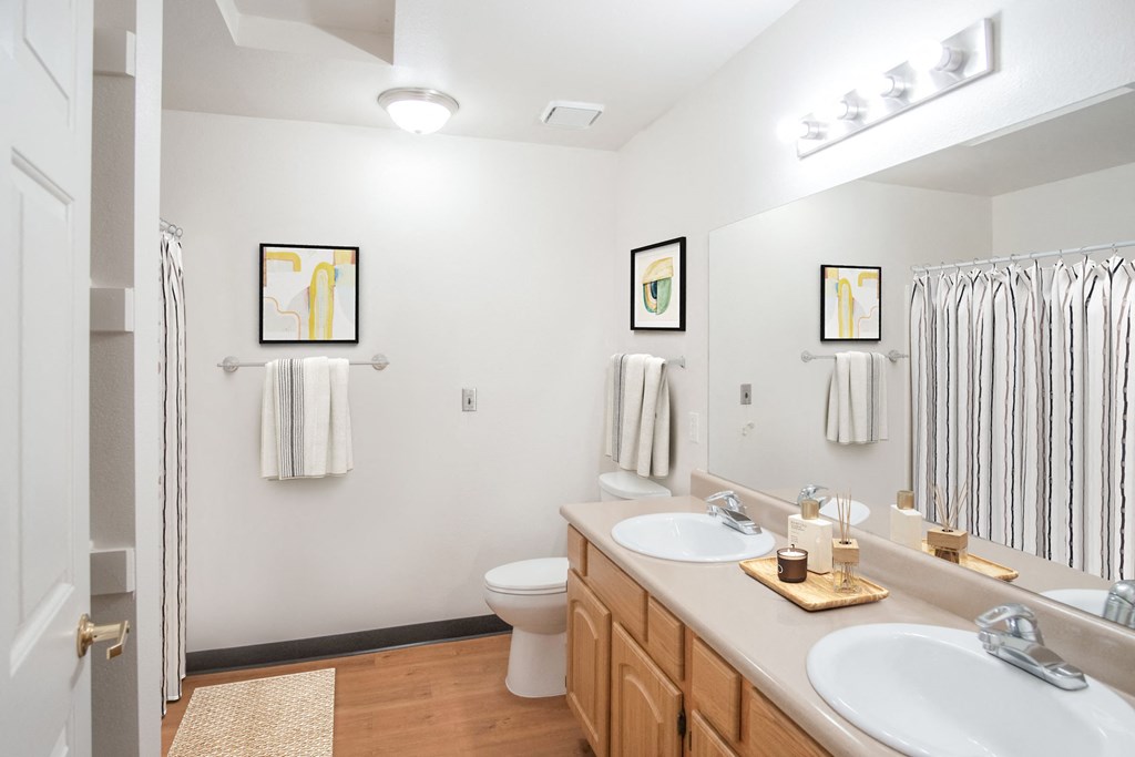 a bathroom with two sinks and a shower and a toilet