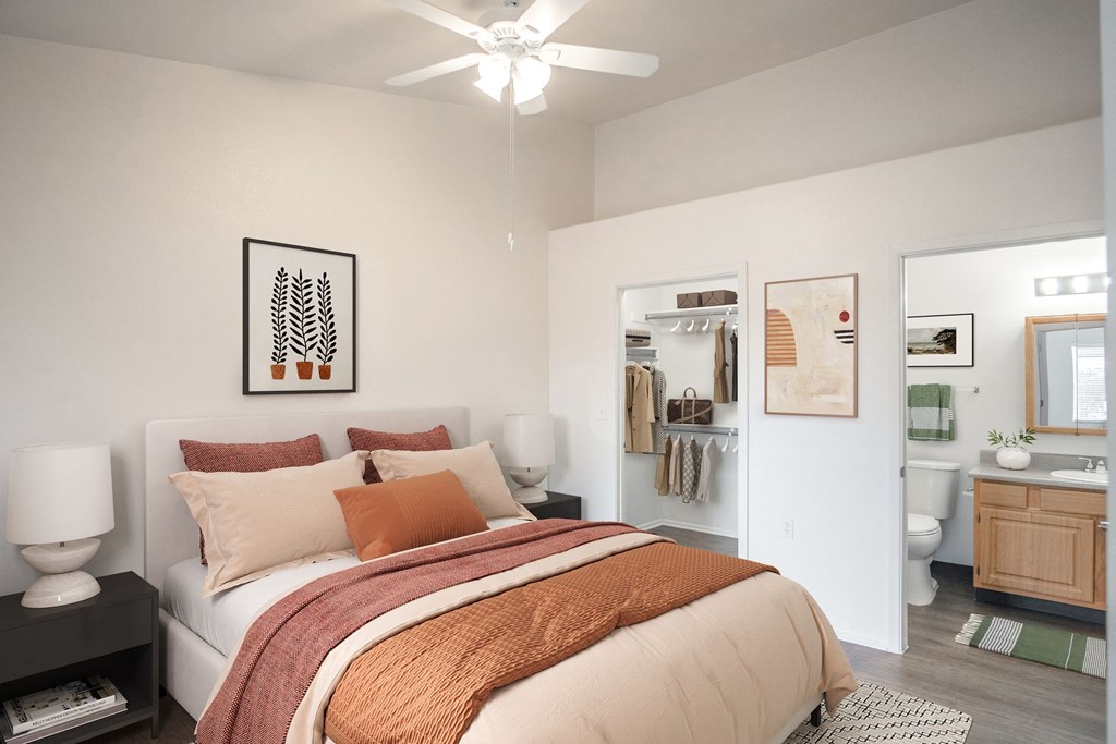 a bedroom with a large bed and a bathroom with a toilet