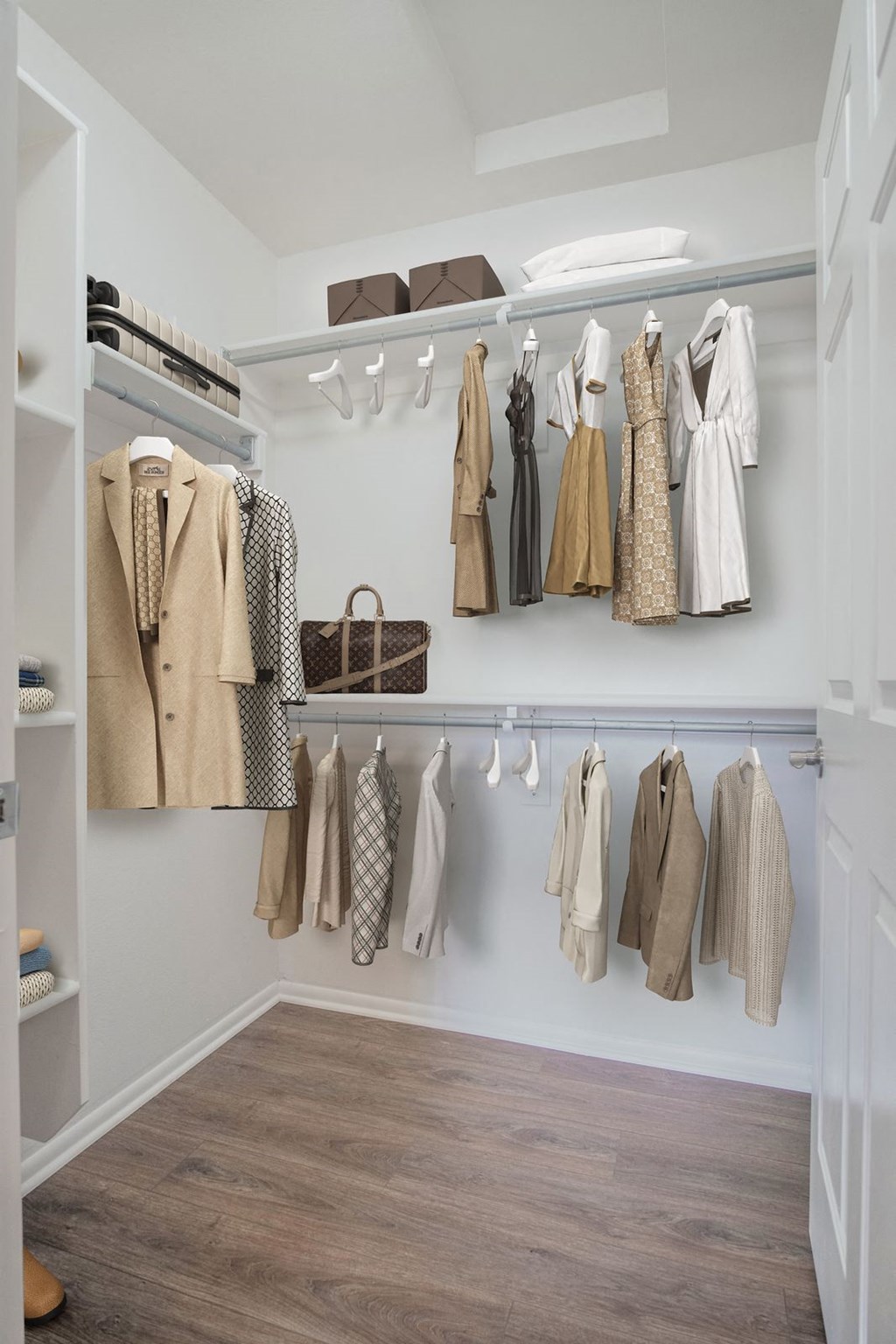 a closet with a rack of clothes in it