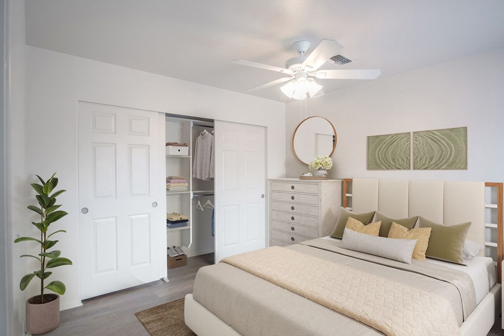 a bedroom with a bed and a ceiling fan