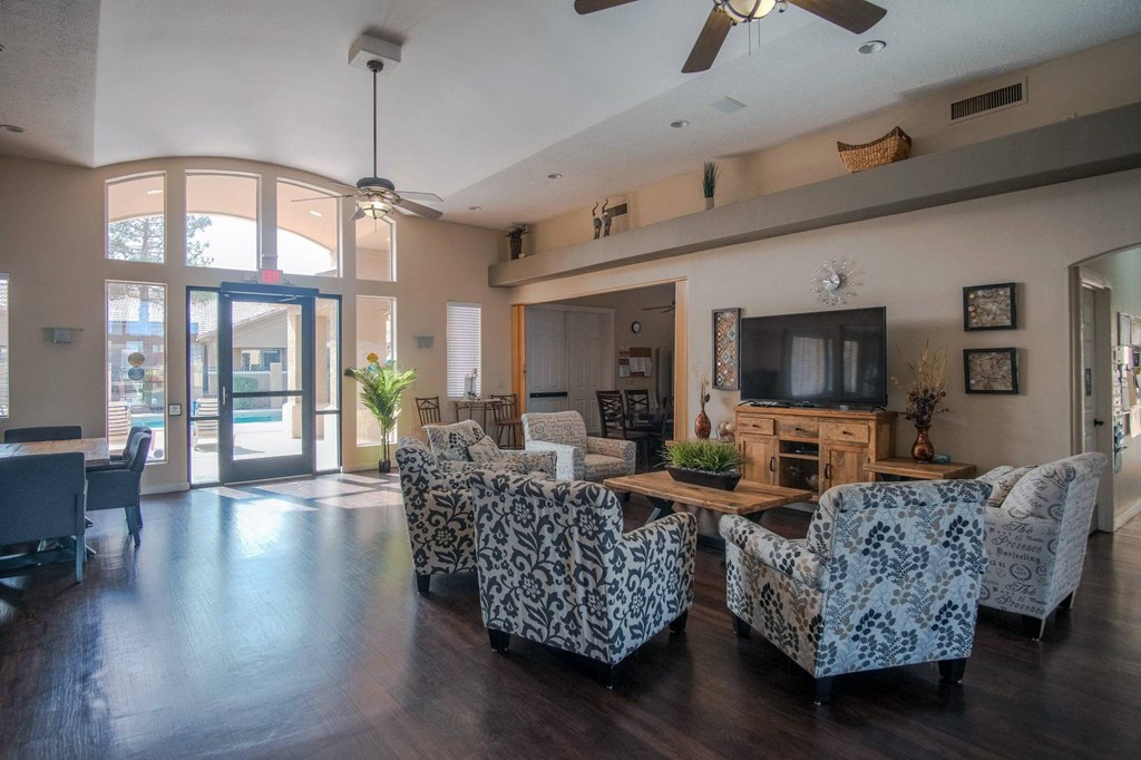 a living room with couches and chairs and a television