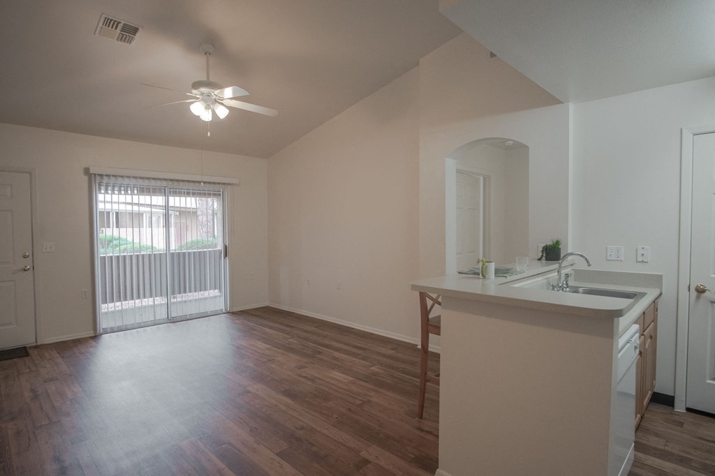 an empty living room and kitchen in an empty house