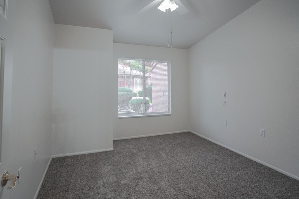 an empty living room with a large window