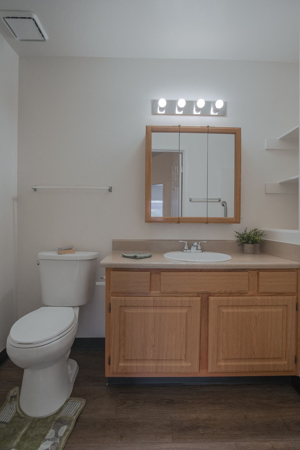a small bathroom with a toilet sink and mirror