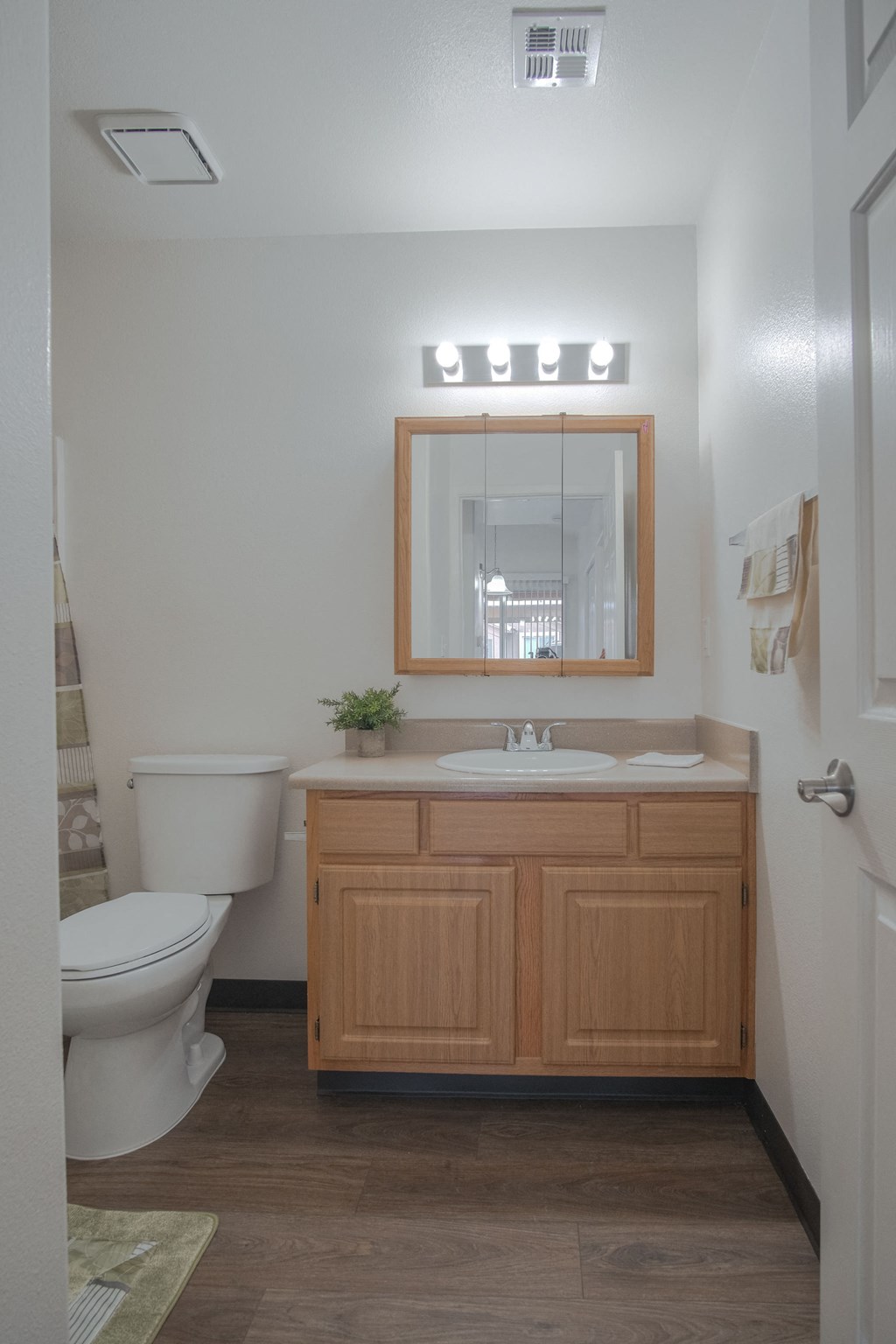 a bathroom with a toilet and a sink and a mirror