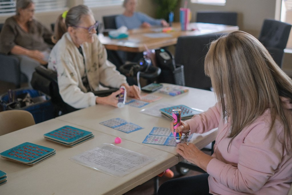 a group of people sitting around a table working on their cell phones