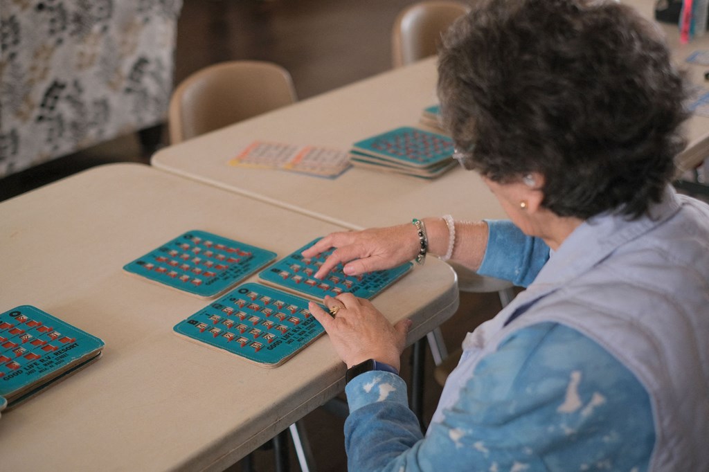 a woman sitting at a desk typing on a computer keyboard
