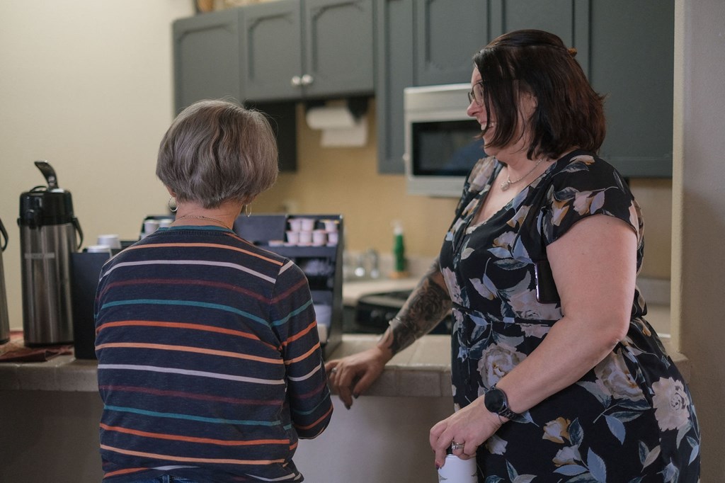 two women in a kitchen talking to each other