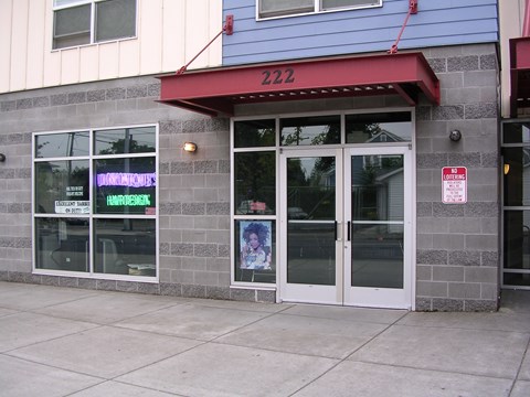 A building with a red awning and a window that says "DINNERMATE" on it.