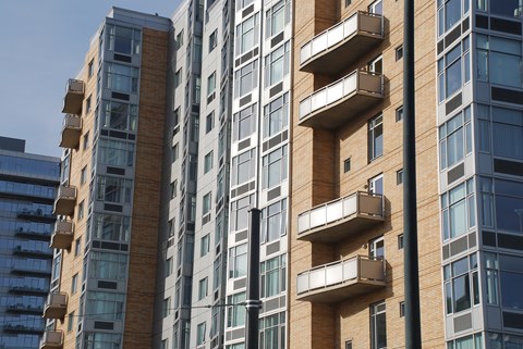 A tall building with balconies on the side.