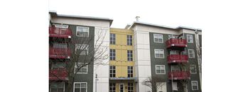 two buildings with red balconies and a yellow building in the middle