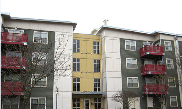 two buildings with red balconies and a yellow building in the middle
