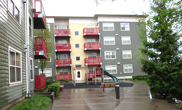 a rainy day in front of an apartment building