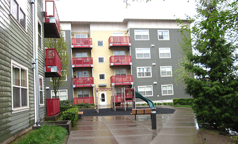 a rainy day in front of an apartment building