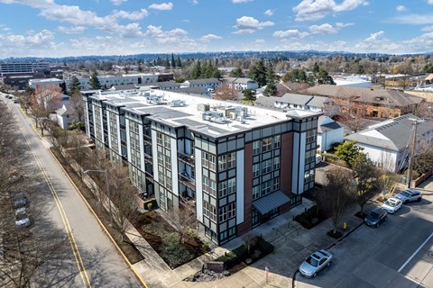an aerial view of a large building with a silver roof