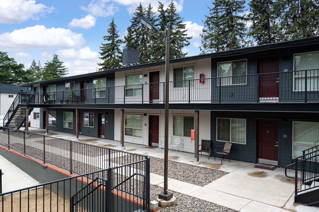 A row of modern townhouses with balconies and black railings.