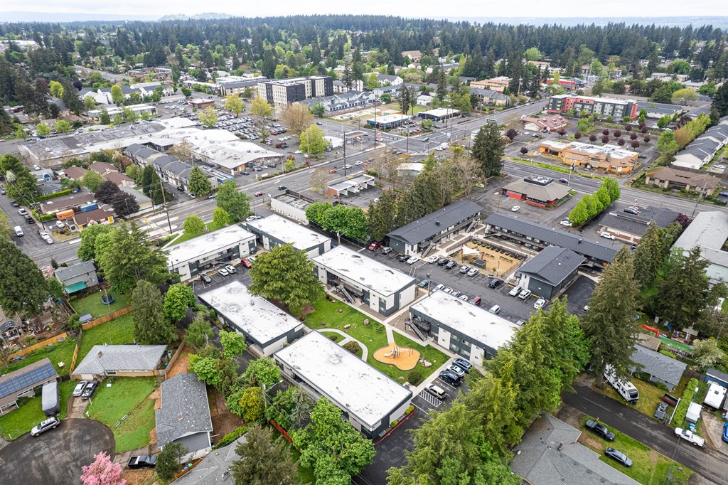 A bird's eye view of a small town with a mix of residential and commercial buildings.