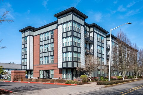 a large brick building with a black and gray roof