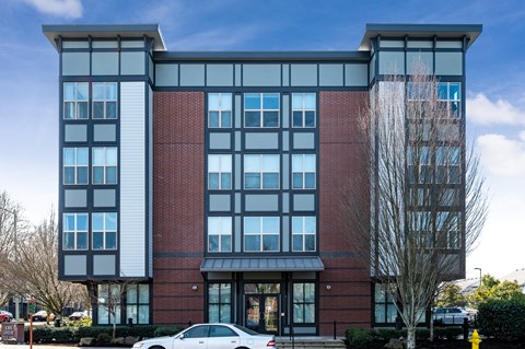 a view of the front of the building with a white car parked in front of it