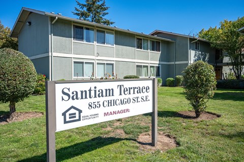 A sign for Santiam Terrace in front of a building.