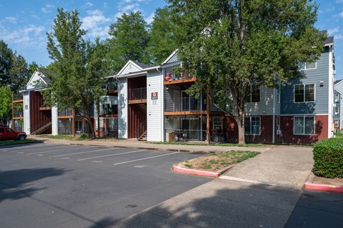 A parking lot with a building in the background.