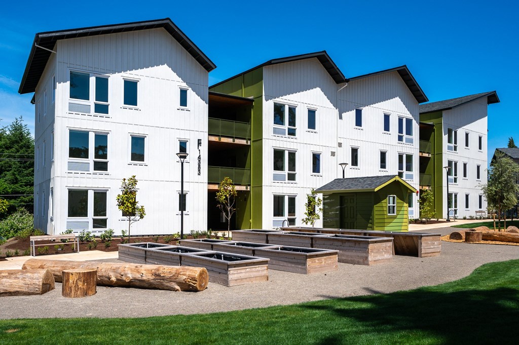 a group of modern buildings with a fire pit in the middle