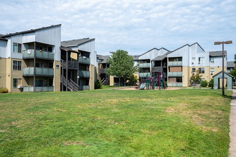 Apartment complex with a playground in the front.