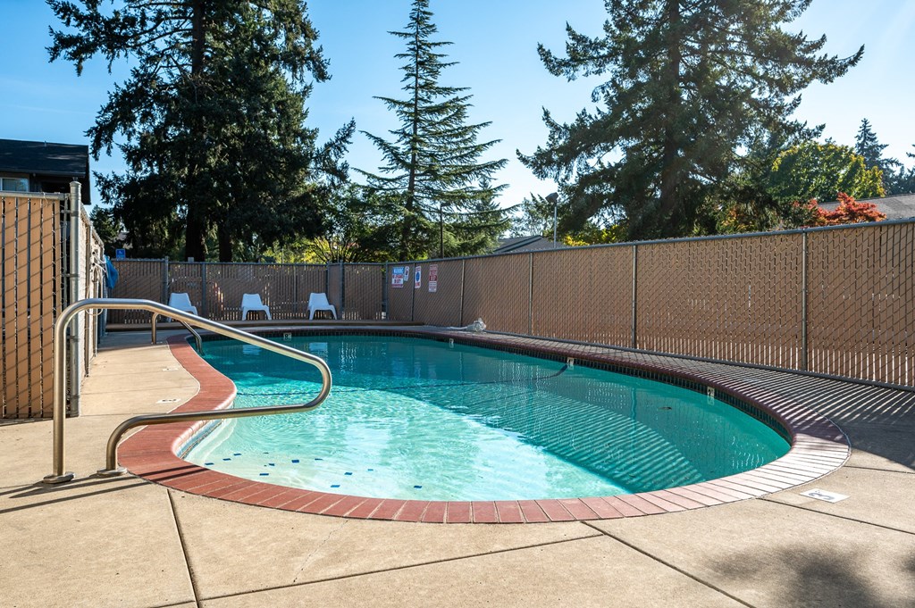 a resort style pool with a fence around it