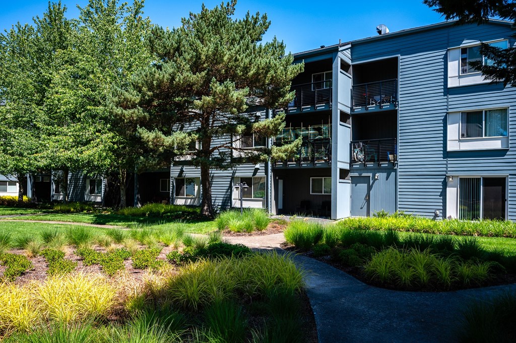 an exterior view of a building with trees and a path