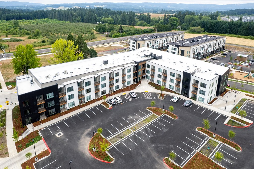 A parking lot in front of apartment buildings.
