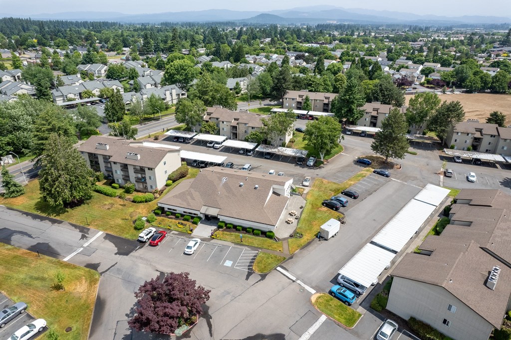 an aerial view of a community with several buildings and a parking lot