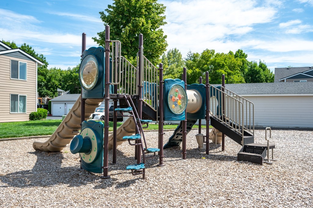 A playground with a slide, swings, and a climbing frame.
